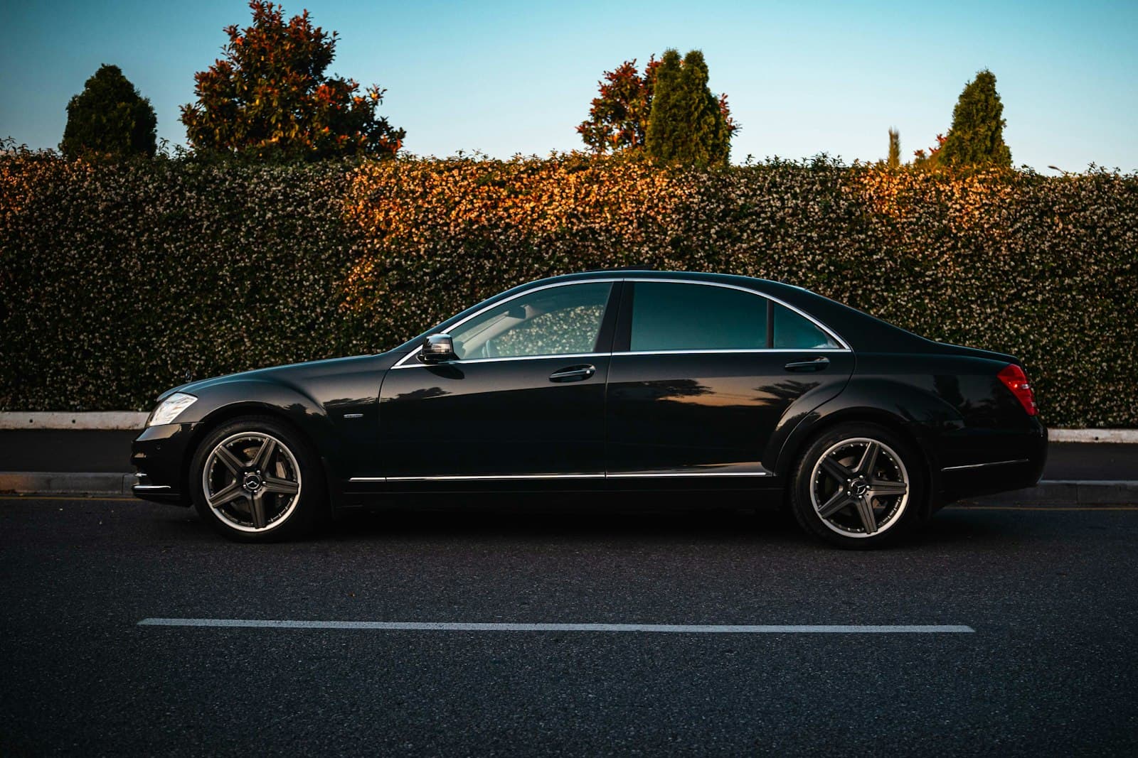 Black luxury sedan parked for chauffeur service